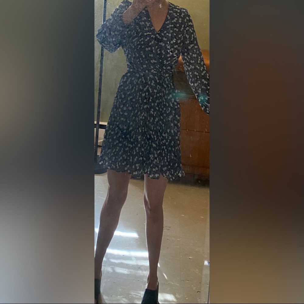 Periwinkle floral baby doll dress with sheer long sleeves and pleats.